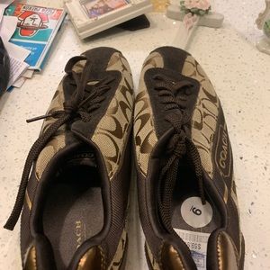 Pair of brown and black coach shoes